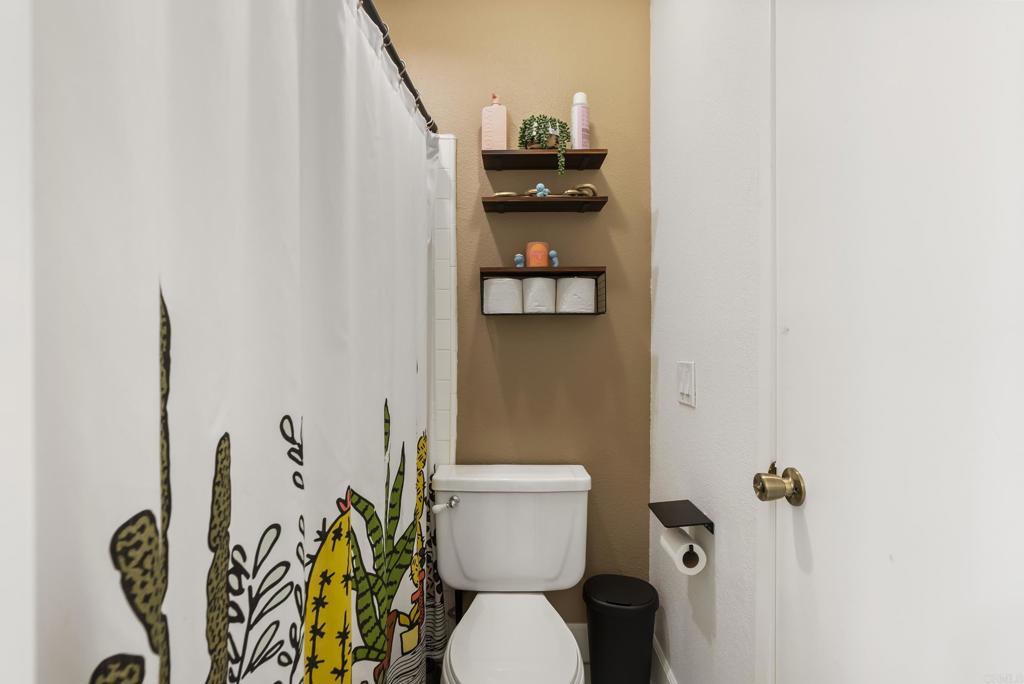 6780 Friars Road, Unit 243 San Diego, CA 92108 - Photo 21 of 31 a bathroom with a toilet and a shower curtain