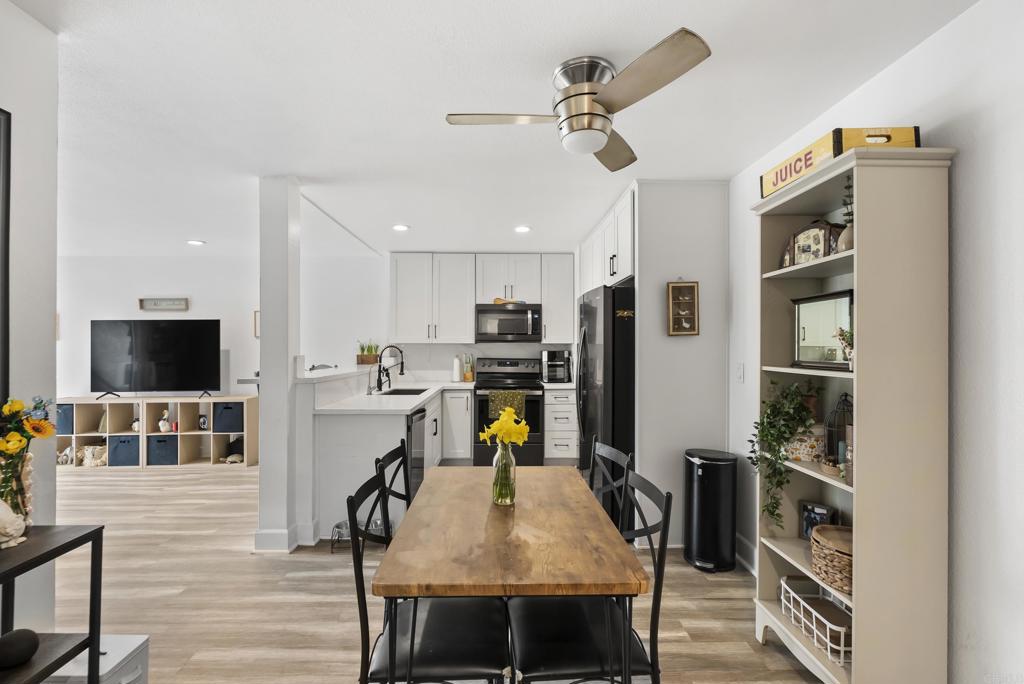 6780 Friars Road, Unit 243 San Diego, CA 92108 - Photo 6 of 31 a view of a dining room with furniture and wooden floor