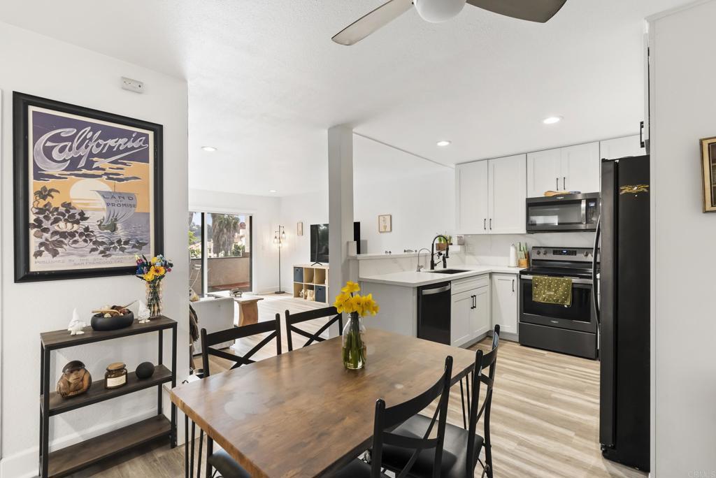 6780 Friars Road, Unit 243 San Diego, CA 92108 - Photo 7 of 31 a kitchen with a table chairs stove and refrigerator