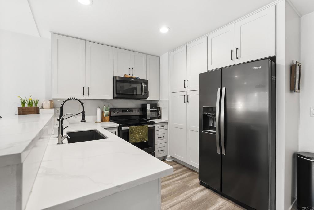 6780 Friars Road, Unit 243 San Diego, CA 92108 - Photo 9 of 31 a kitchen with a refrigerator and a sink