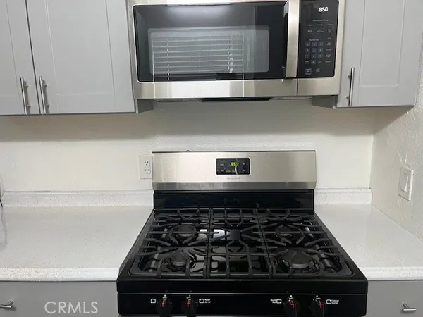 a close view of a stove a microwave and cabinets in the kitchen