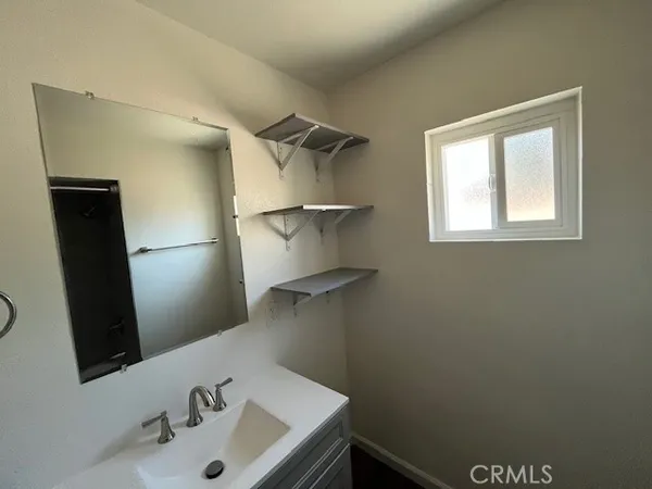 a bathroom with a sink and mirror