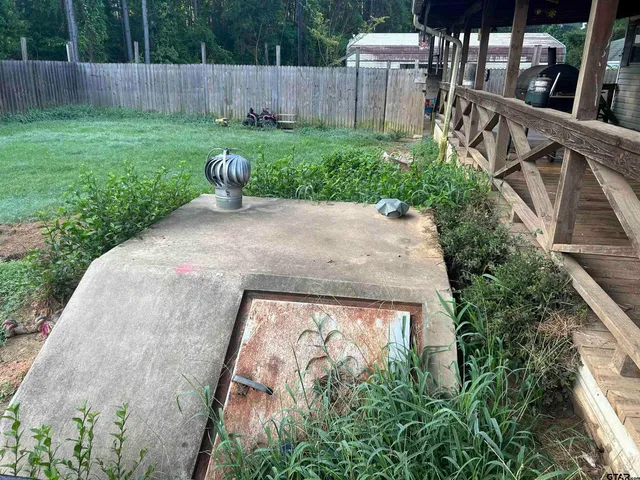 a view of a backyard with wooden fence