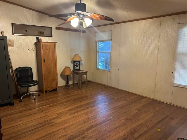 a view of a livingroom with furniture and a window