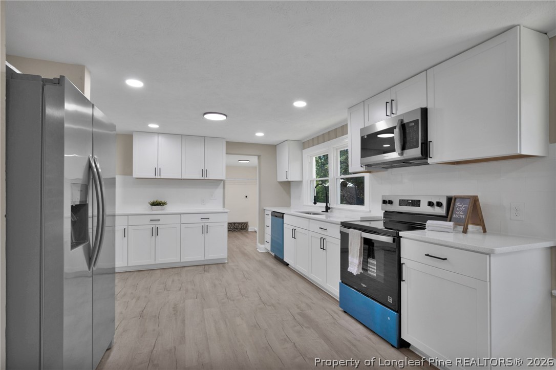 88 Hannah Creek Road Four Oaks, NC 27524 - Photo 12 of 31 a kitchen with a sink stainless steel appliances and cabinets