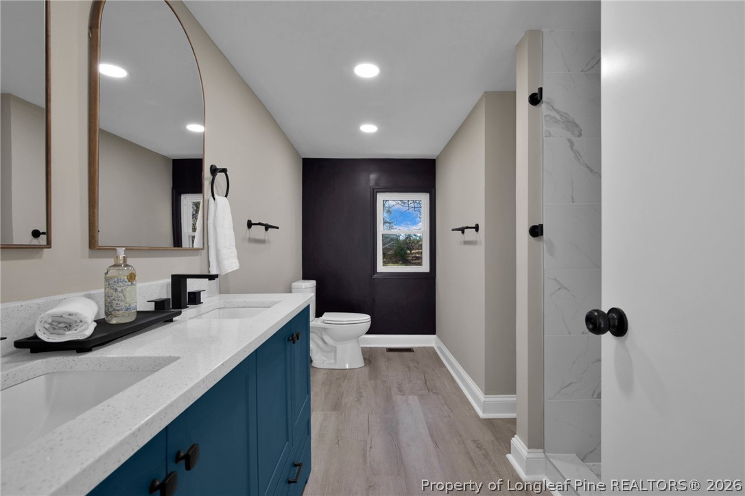 88 Hannah Creek Road Four Oaks, NC 27524 - Photo 19 of 31 a bathroom with a double vanity sink and mirror