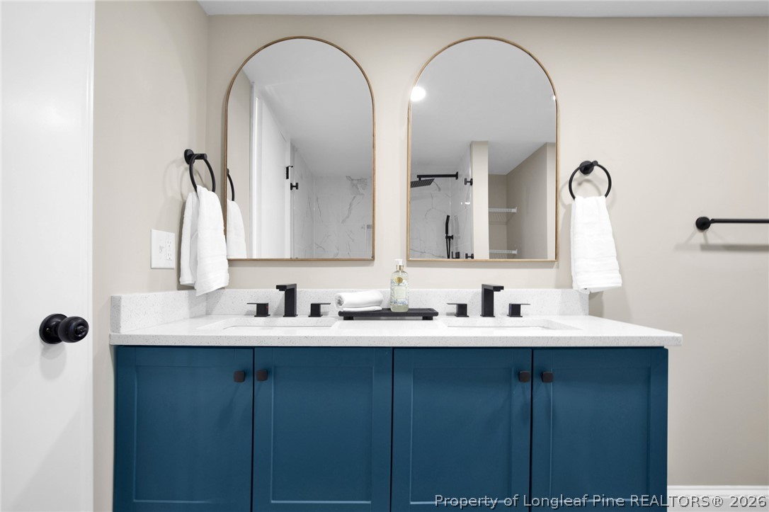 88 Hannah Creek Road Four Oaks, NC 27524 - Photo 21 of 31 a bathroom with a double vanity sink and a mirror