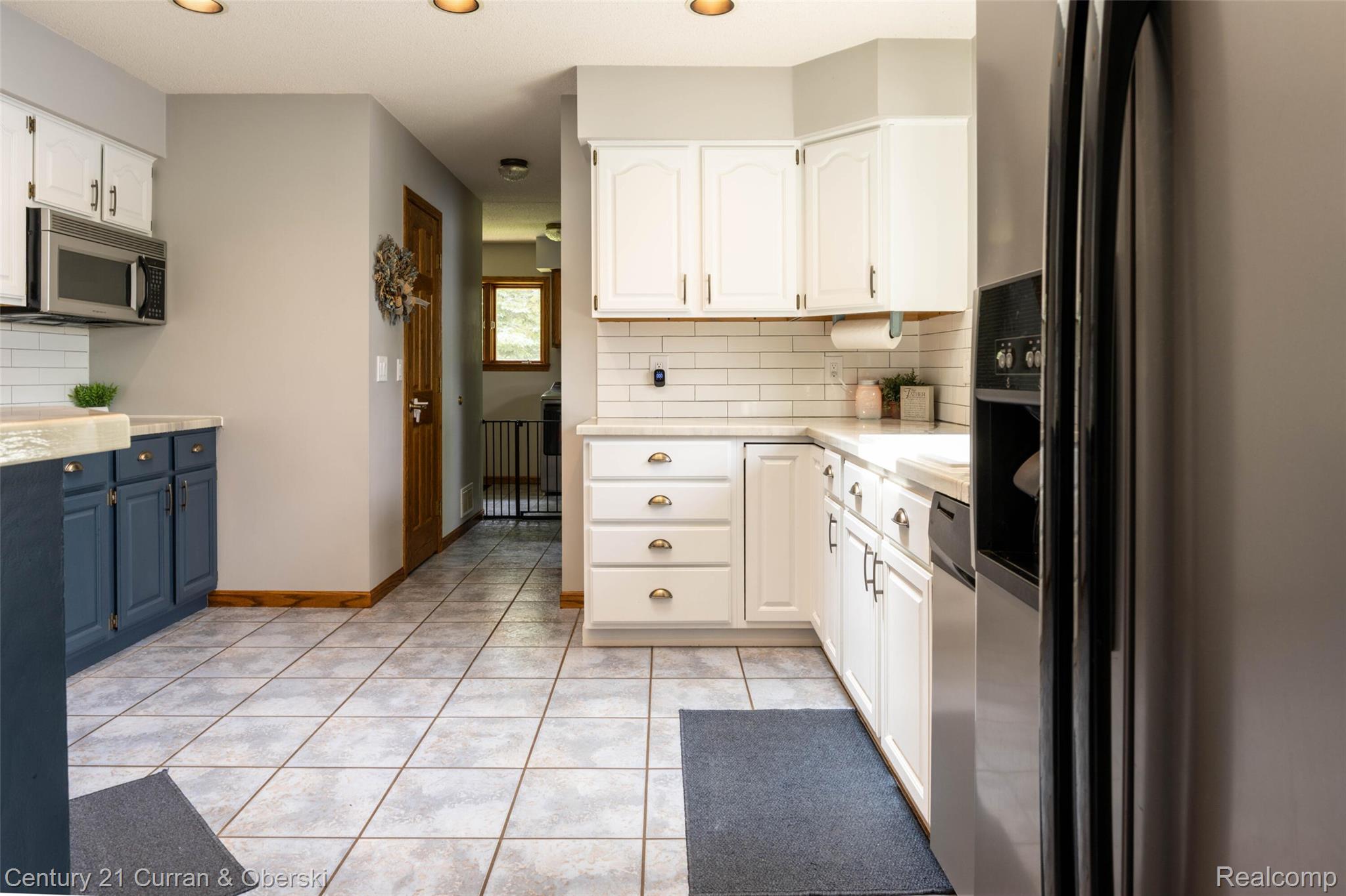 8775 Winding Rdg Drive Millersburg, MI 49759 - Photo 15 of 53 Kitchen featuring light-toned square floor tiling, white subway tile backsplash, and recessed lighting