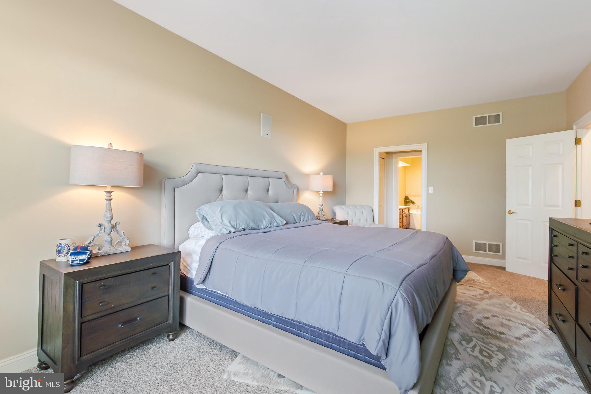 616 Northfield Road Lititz, PA 17543 - Photo 13 of 30 a bedroom with a bed and a lamp