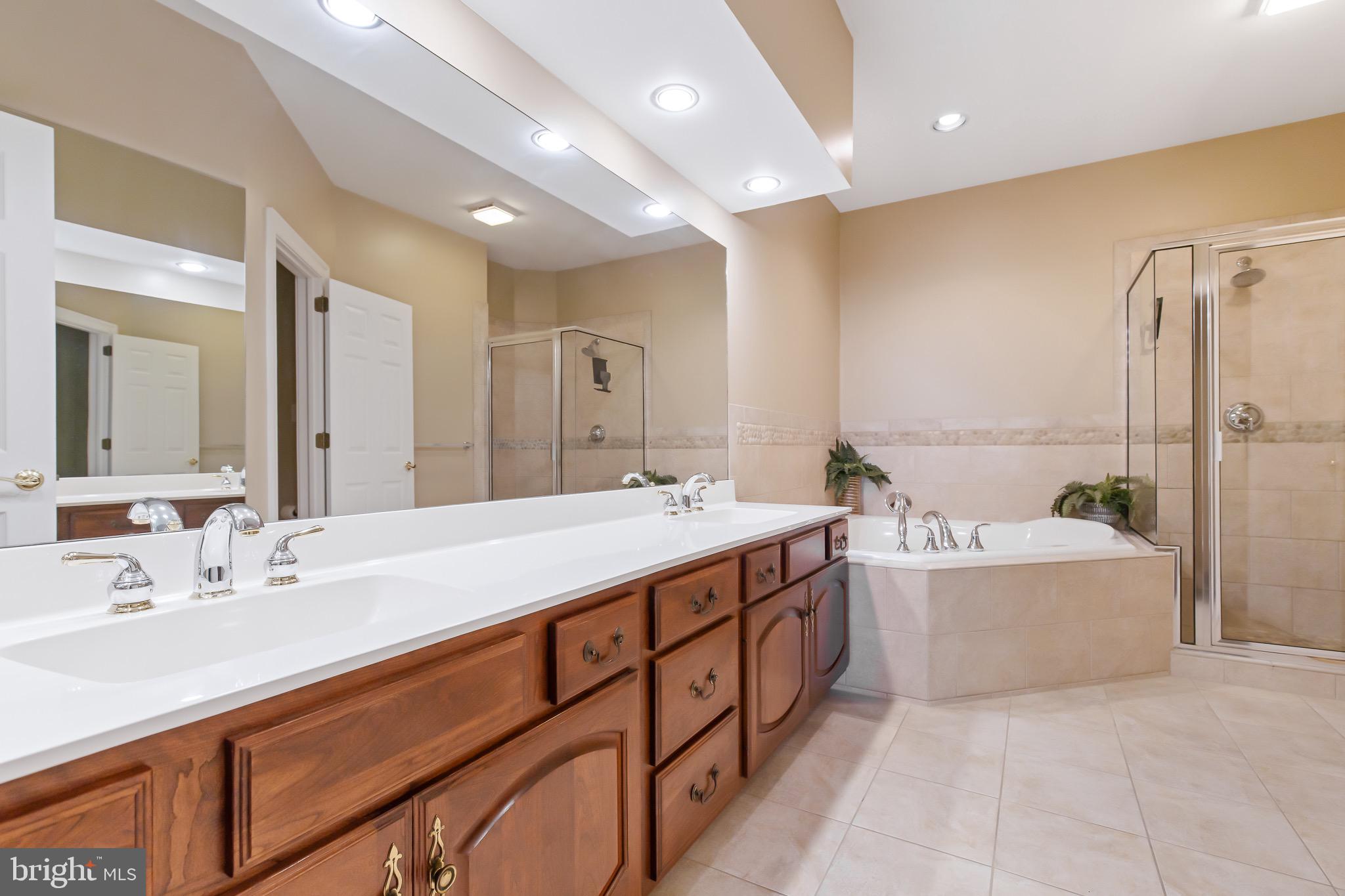 616 Northfield Road Lititz, PA 17543 - Photo 14 of 30 a spacious bathroom with a double vanity sink mirror and bathtub