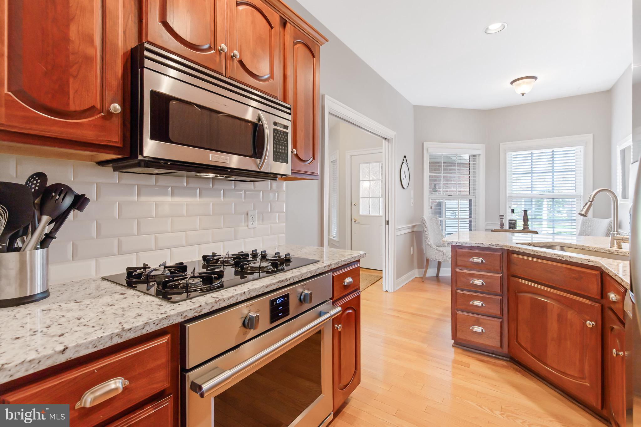 616 Northfield Road Lititz, PA 17543 - Photo 6 of 30 a kitchen with stainless steel appliances granite countertop a stove and a microwave