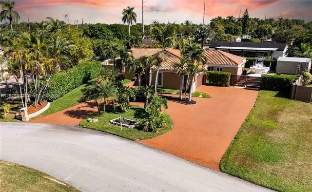 a view of a swimming pool with a patio and a garden