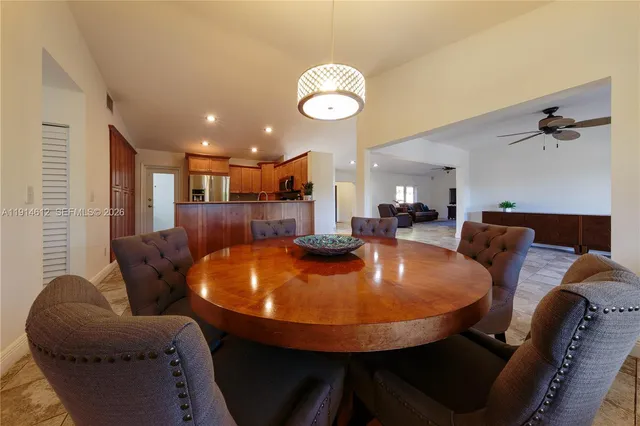 a view of a dining room with furniture and a chandelier