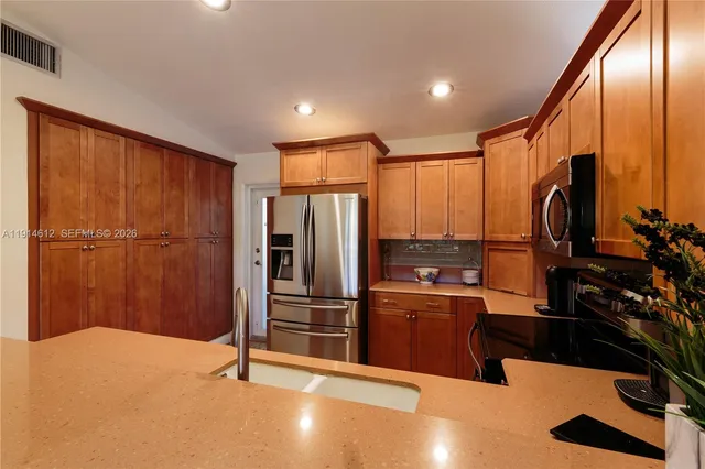 a kitchen with stainless steel appliances a refrigerator and a sink