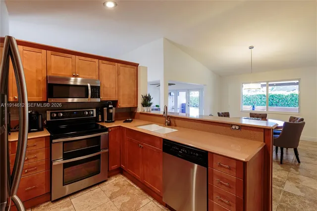 a kitchen with a stove a sink and a refrigerator