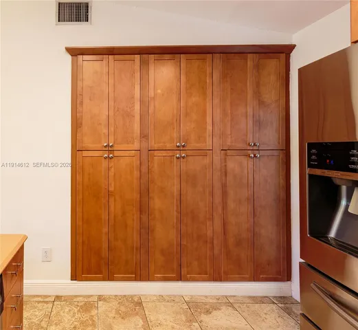 a spacious bathroom with a mirror a sink and a mirror