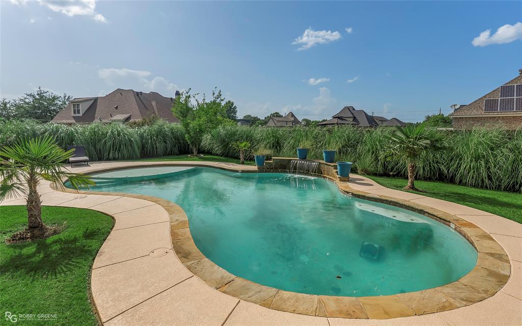 4743 Old Brownlee Road Bossier City, LA 71111 - Photo 11 of 40 a view of a swimming pool with a yard and large trees