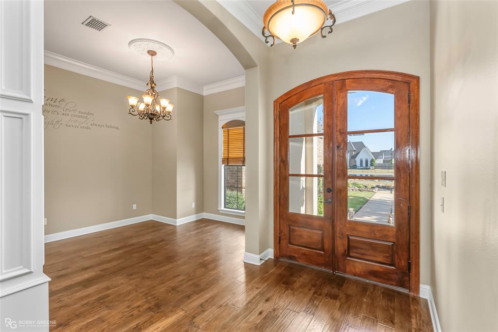 4743 Old Brownlee Road Bossier City, LA 71111 - Photo 14 of 40 an empty room with wooden floor fan and windows
