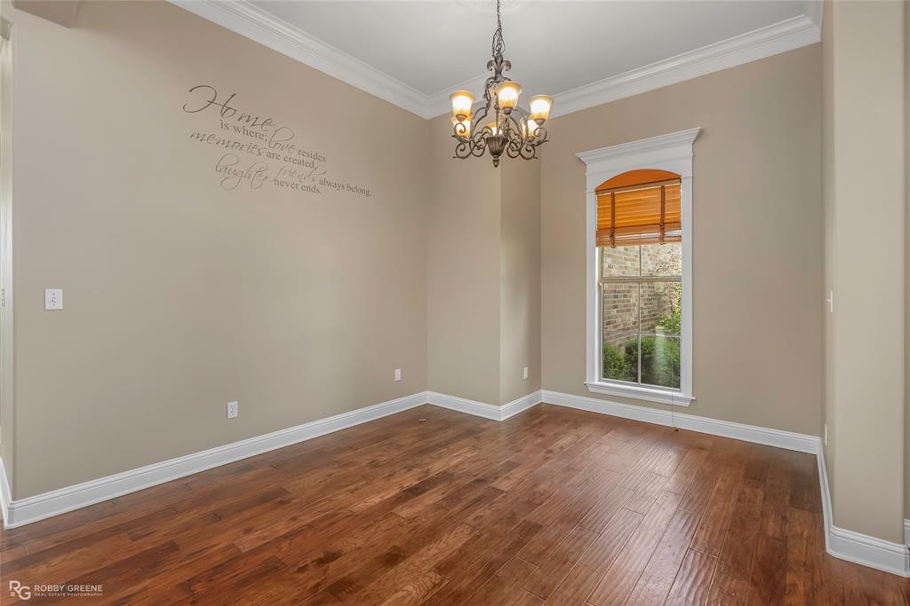 4743 Old Brownlee Road Bossier City, LA 71111 - Photo 15 of 40 a view of an empty room with wooden floor and a window