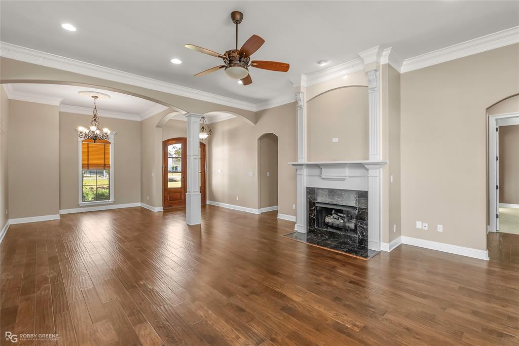 4743 Old Brownlee Road Bossier City, LA 71111 - Photo 17 of 40 an empty room with wooden floor fireplace and windows