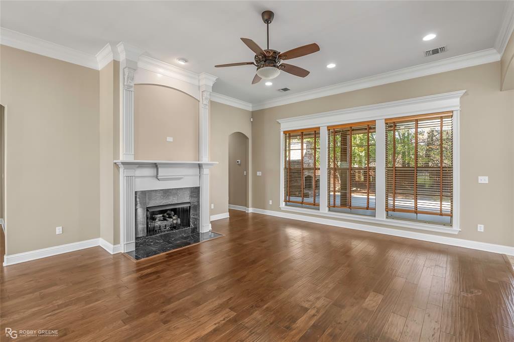 4743 Old Brownlee Road Bossier City, LA 71111 - Photo 18 of 40 a view of an empty room with wooden floor and a fireplace