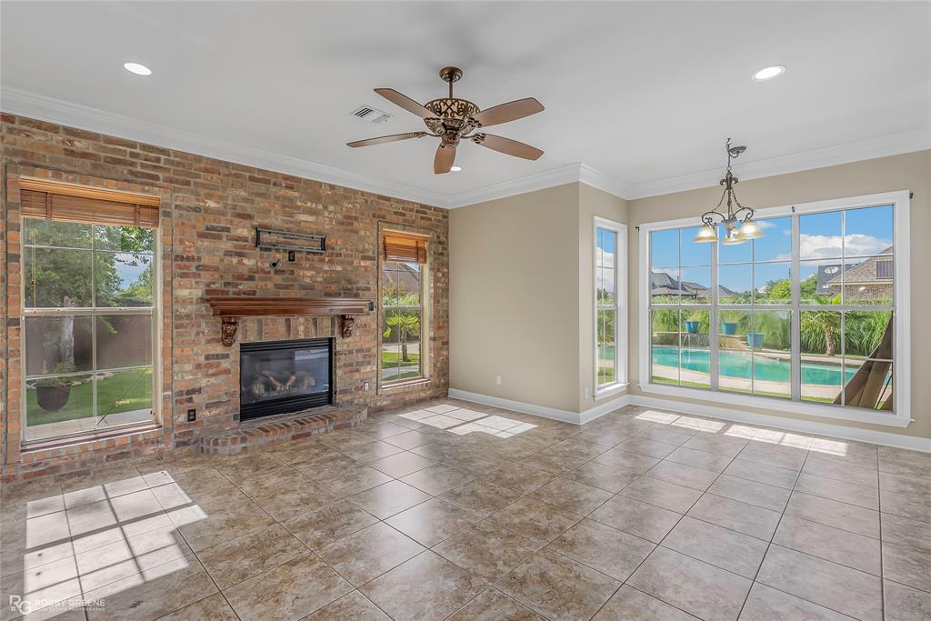 4743 Old Brownlee Road Bossier City, LA 71111 - Photo 21 of 40 a view of an empty room with a fireplace and a large window