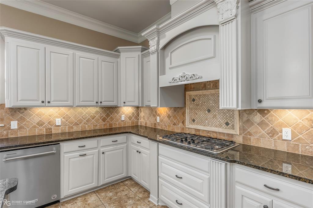 4743 Old Brownlee Road Bossier City, LA 71111 - Photo 25 of 40 a kitchen with granite countertop white cabinets and white appliances