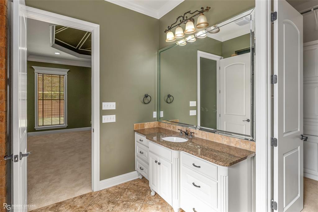 4743 Old Brownlee Road Bossier City, LA 71111 - Photo 27 of 40 a spacious bathroom with a granite countertop sink and a mirror