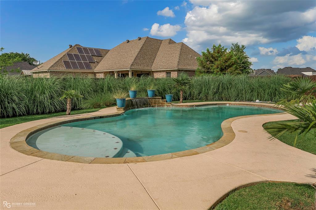 4743 Old Brownlee Road Bossier City, LA 71111 - Photo 10 of 40 a view of a swimming pool with a yard and plants