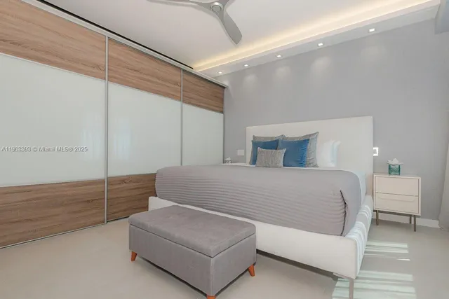 a bedroom with a bed window and walk in closet