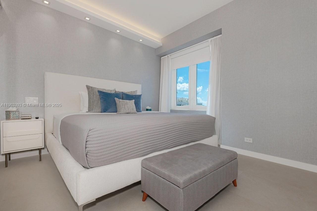 2301 Collins Avenue, Unit PH20 Miami Beach, FL 33139 - Photo 16 of 28 a bedroom with a bed and a potted plant