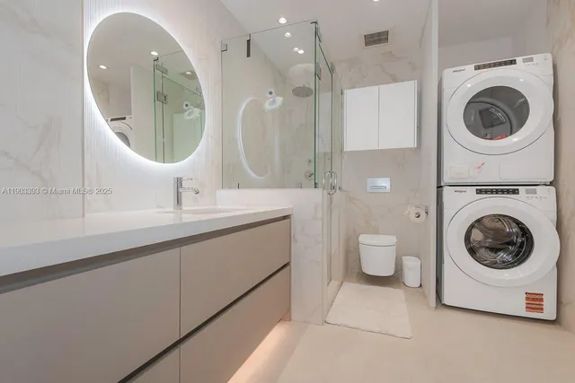a bathroom with a double vanity sink mirror and toilet