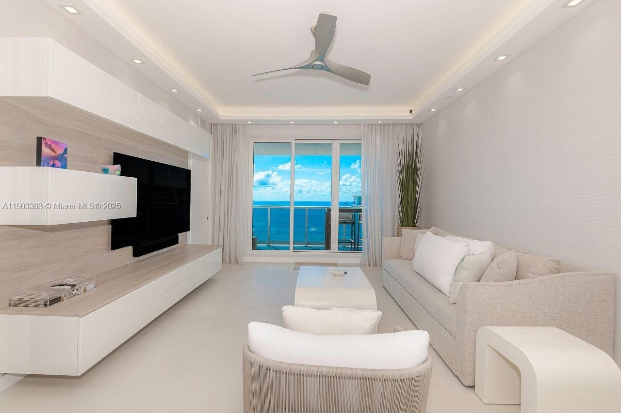 2301 Collins Avenue, Unit PH20 Miami Beach, FL 33139 - Photo 2 of 28 a living room with furniture and a flat screen tv