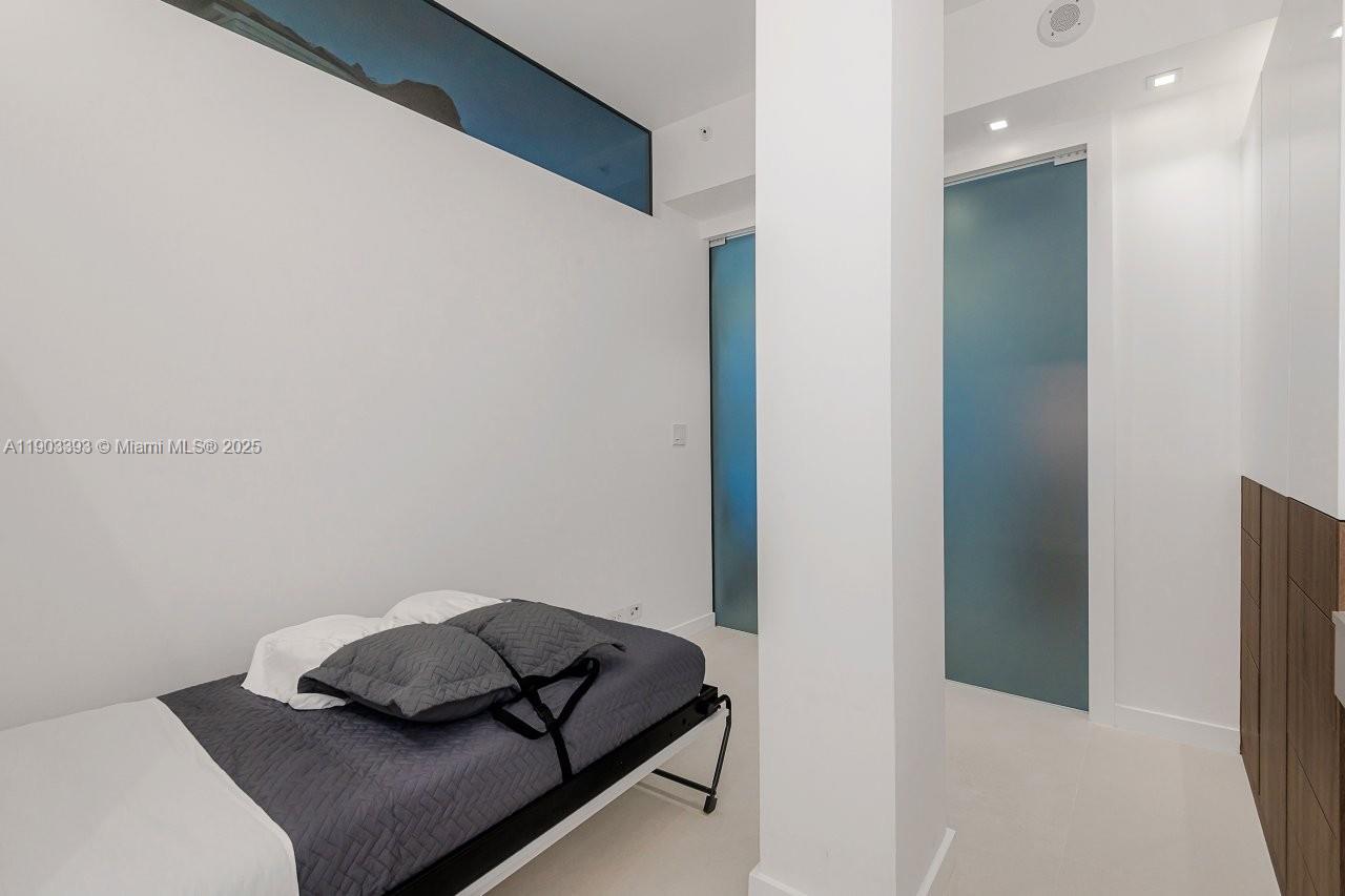 2301 Collins Avenue, Unit PH20 Miami Beach, FL 33139 - Photo 23 of 28 a room that has a bed and a chair