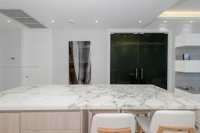 a bathroom with a granite countertop sink a toilet and shower