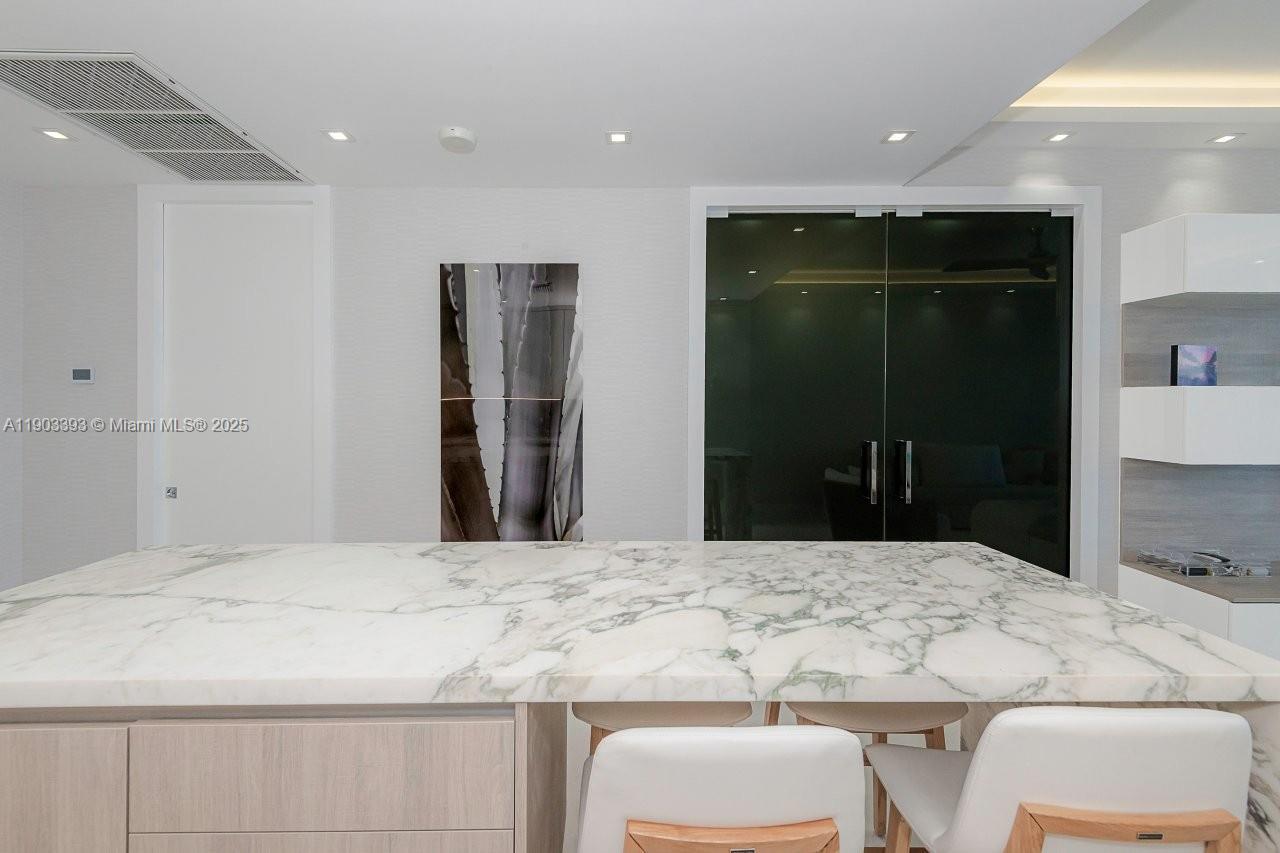 2301 Collins Avenue, Unit PH20 Miami Beach, FL 33139 - Photo 10 of 28 a bathroom with a granite countertop sink a toilet and shower