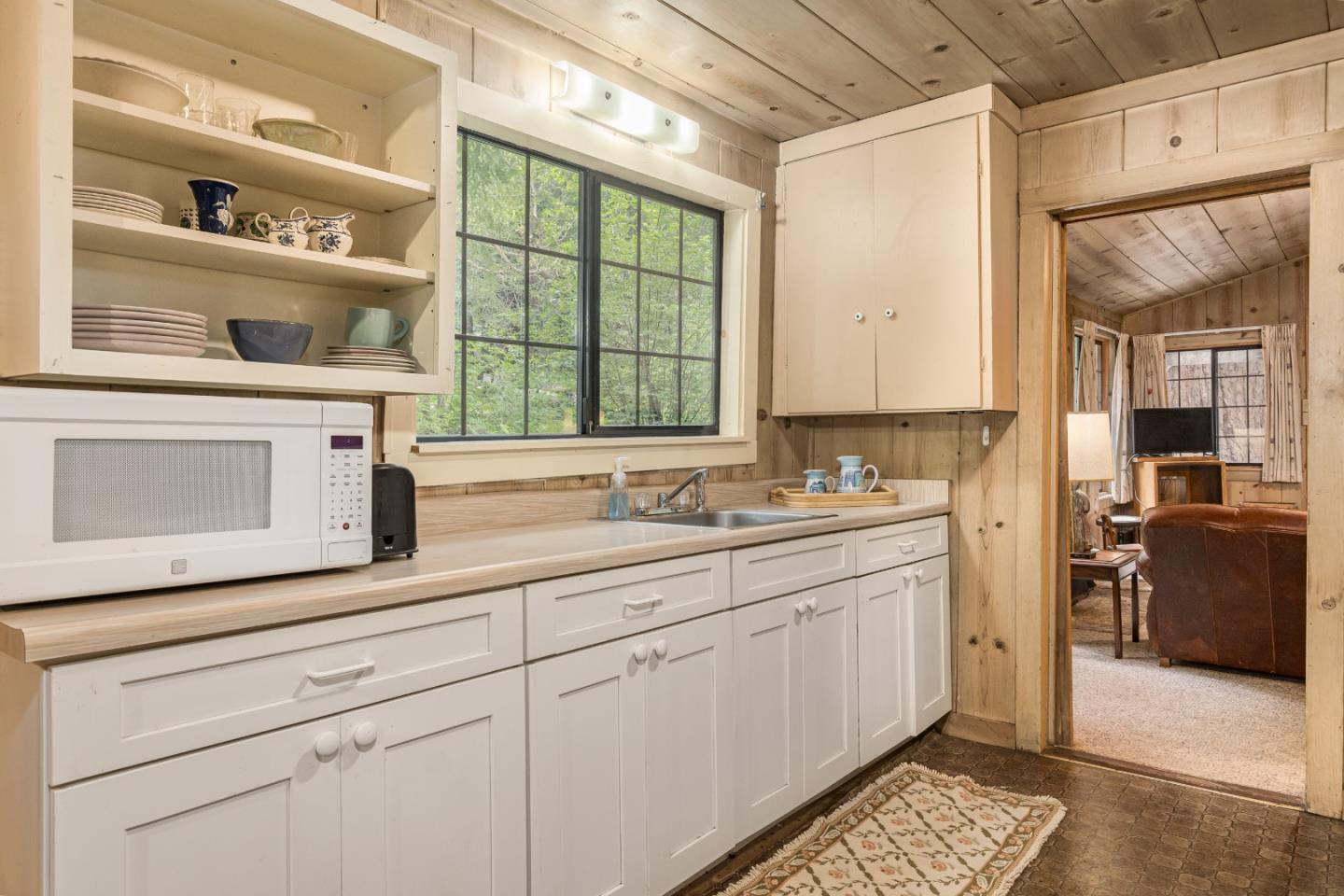 155 Brier Drive Boulder Creek, CA 95006 - Photo 11 of 42 a utility room with stainless steel appliances cabinets and a large window