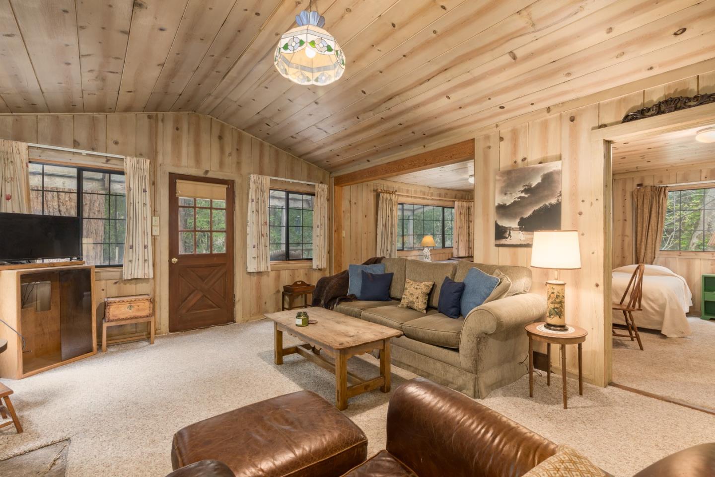 155 Brier Drive Boulder Creek, CA 95006 - Photo 8 of 42 a living room with furniture a flat screen tv and large window