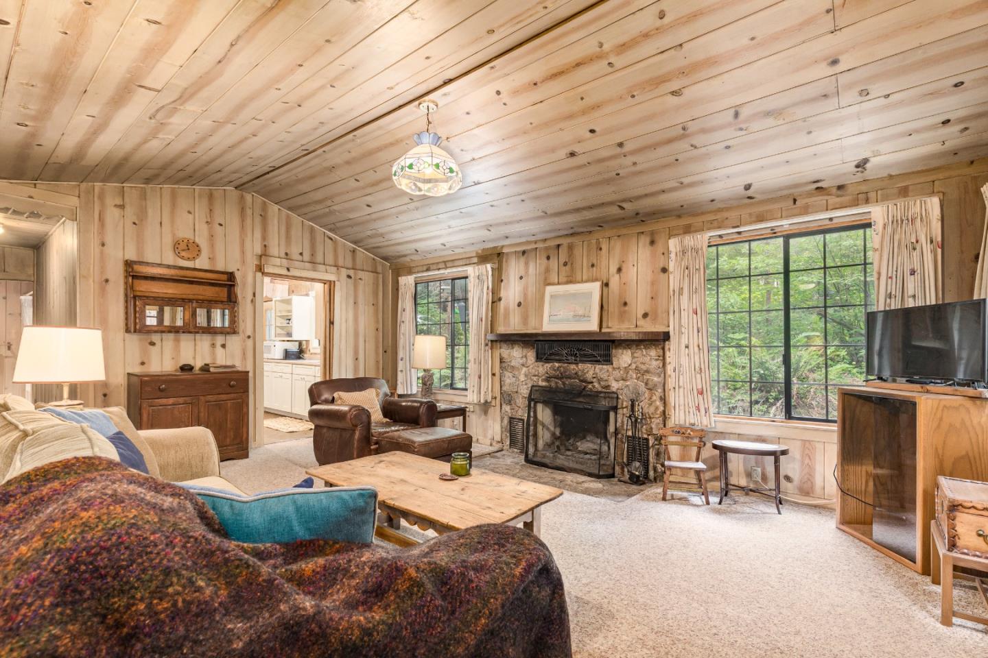 155 Brier Drive Boulder Creek, CA 95006 - Photo 9 of 42 a bedroom with furniture a fireplace and a window
