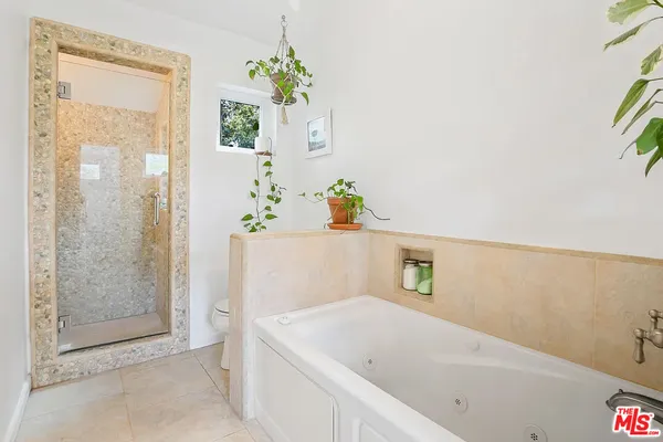 a bathroom with a bathtub and a shower