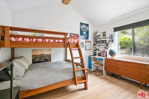 a bedroom with furniture and a large window