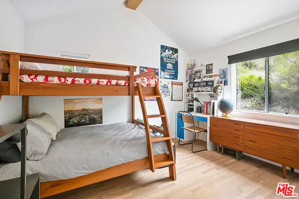 a bedroom with furniture and a large window
