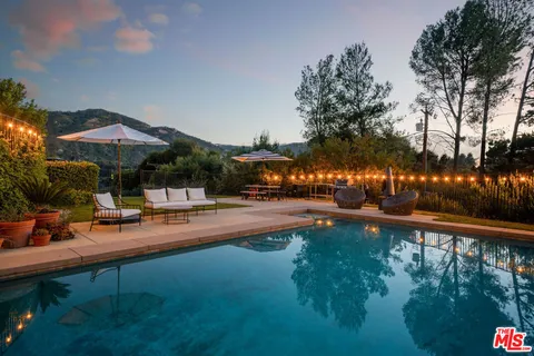 a view of a swimming pool of water with a bench