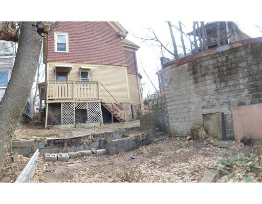 2 Dunford Street Boston, MA 02119 - Photo 3 of 4 a front view of a house with a yard