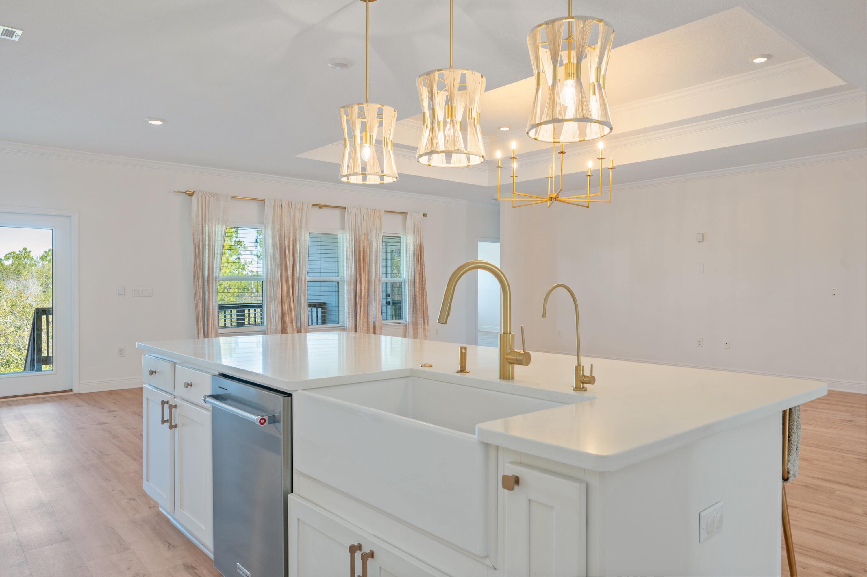 53 Palmer Lane Santa Rosa Beach, FL 32459 - Photo 14 of 62 a kitchen with stainless steel appliances a table and chandelier