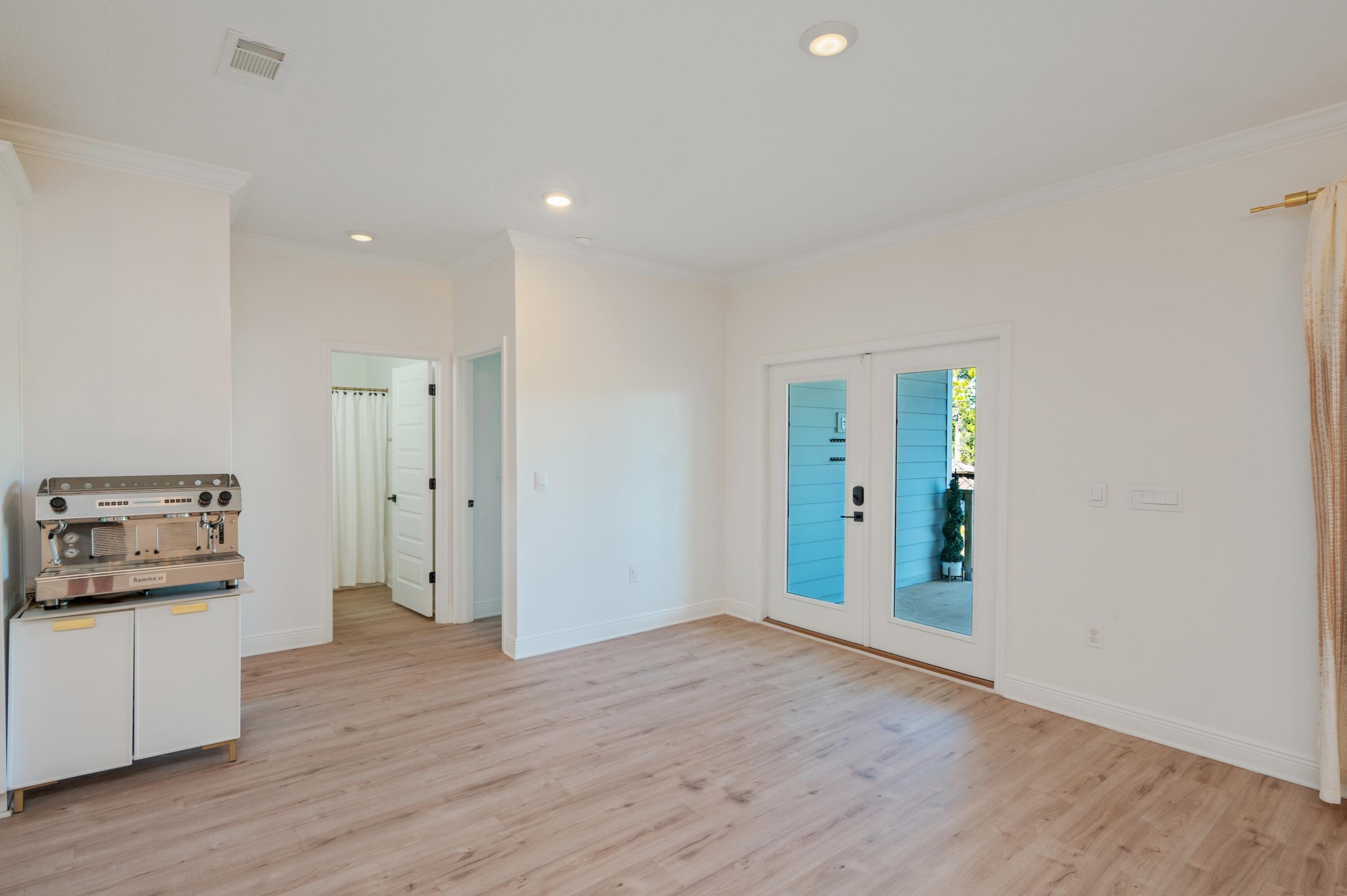 53 Palmer Lane Santa Rosa Beach, FL 32459 - Photo 16 of 62 a view of a kitchen with refrigerator and wooden floor