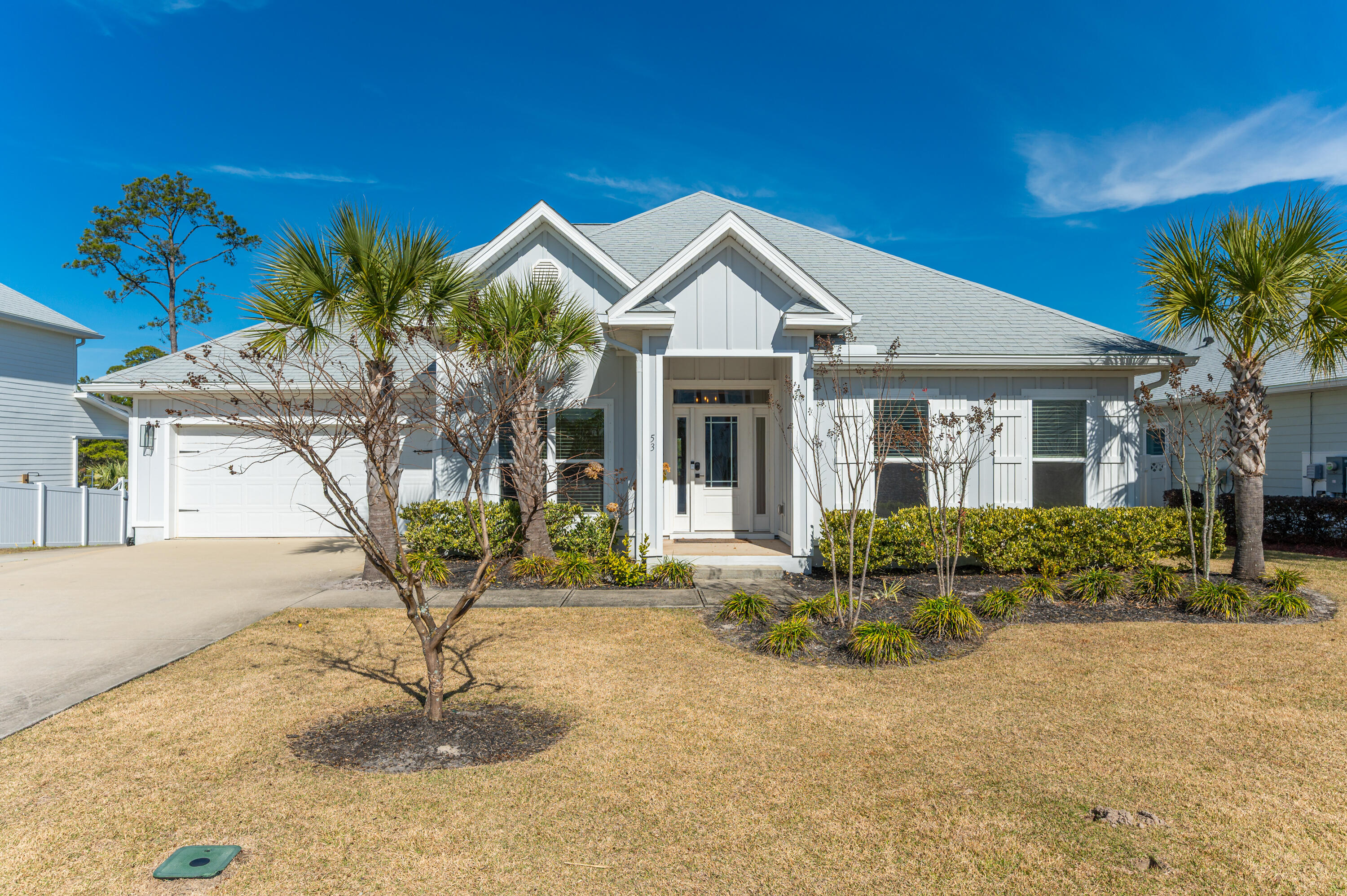 53 Palmer Lane Santa Rosa Beach, FL 32459 - Photo 2 of 62 a front view of a house with garden