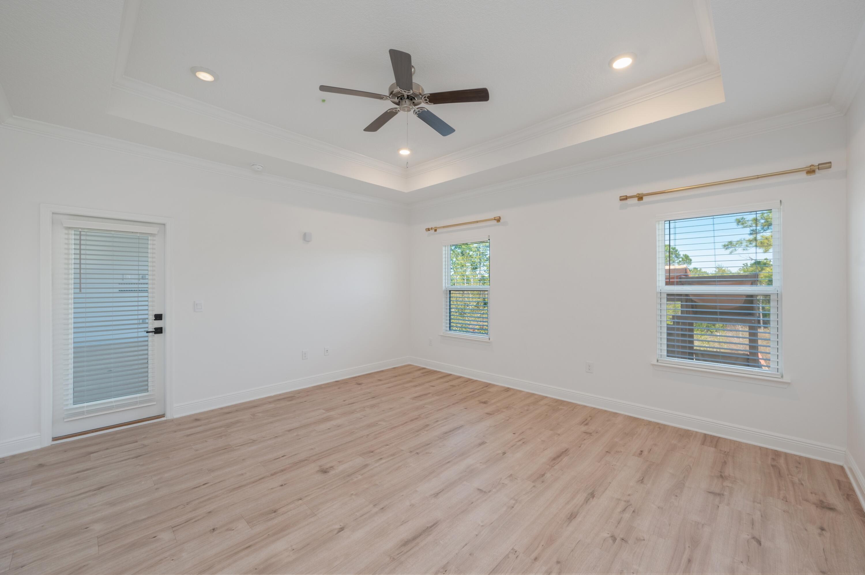 53 Palmer Lane Santa Rosa Beach, FL 32459 - Photo 25 of 62 wooden floor in an empty room with a window