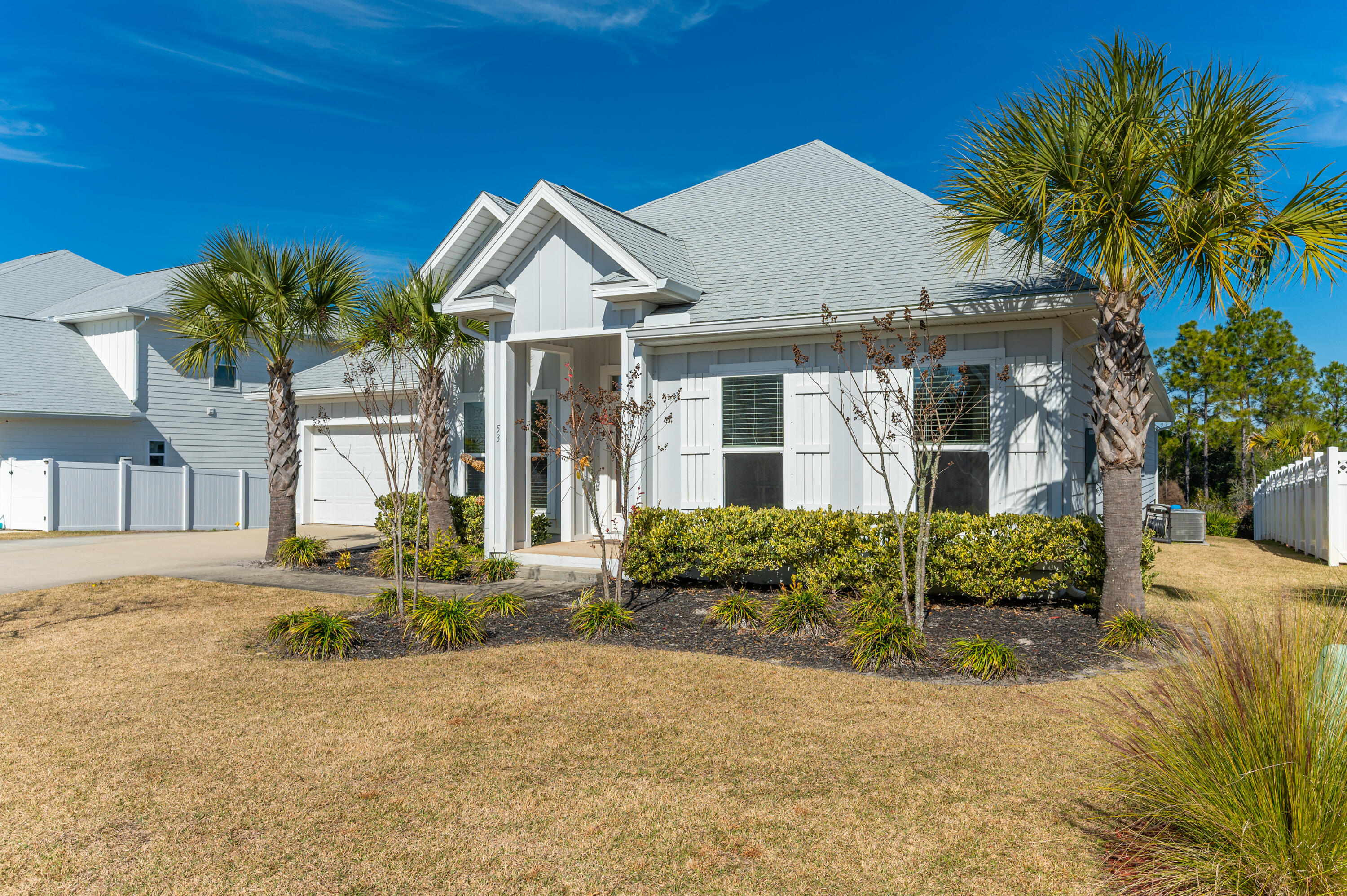 53 Palmer Lane Santa Rosa Beach, FL 32459 - Photo 3 of 62 a front view of a house with a yard and potted plants