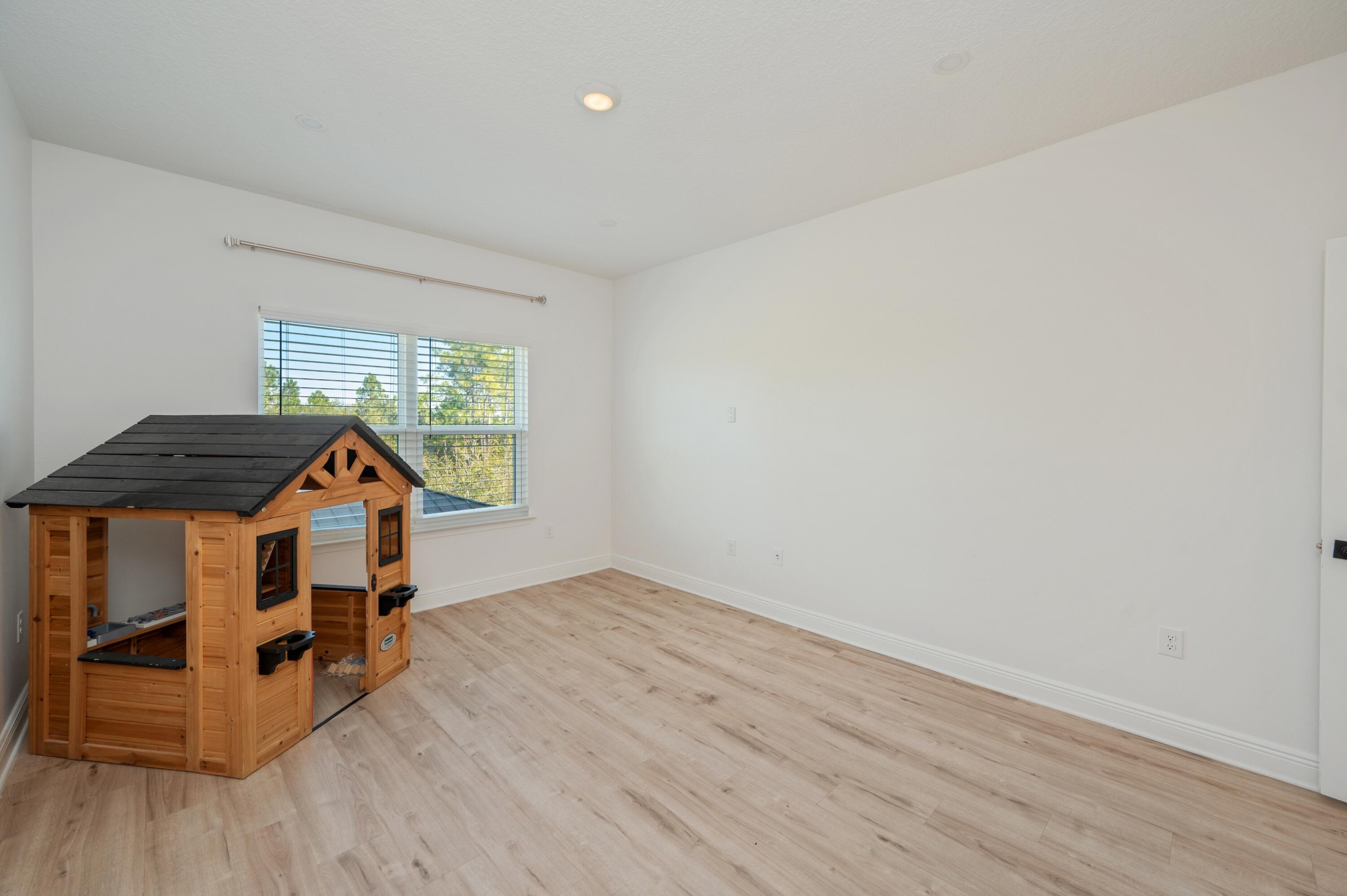 53 Palmer Lane Santa Rosa Beach, FL 32459 - Photo 33 of 62 an empty room with wooden floor closet and windows